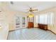 The bright dining room includes tiled floors, a ceiling fan, and sliding glass doors to the lanai at 3029 Harrow Rd, Spring Hill, FL 34606
