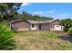 Charming single story home featuring wood paneled and stone exterior with a well maintained lawn, and attached garage at 3029 Harrow Rd, Spring Hill, FL 34606