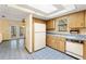 Cozy kitchen features wood cabinets, blue countertops and tile floors, and a bright skylight at 3029 Harrow Rd, Spring Hill, FL 34606