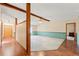 Spacious living room with hardwood floors, ceiling fan, and neutral paint, featuring a doorway and wall partition at 3029 Harrow Rd, Spring Hill, FL 34606