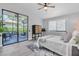 Bright bedroom with a sliding glass door to outdoor seating area and woven wood furniture at 3047 Bolt Dr, Palm Harbor, FL 34685