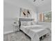 A bright bedroom features a comfortable bed, side tables, and natural light at 3047 Bolt Dr, Palm Harbor, FL 34685