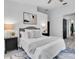 Comfortable bedroom featuring a full-size bed, nightstands, and an ensuite bathroom at 3047 Bolt Dr, Palm Harbor, FL 34685