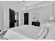 Comfortable bedroom features a vaulted ceiling, elegant decor, and an ensuite bathroom entry at 3047 Bolt Dr, Palm Harbor, FL 34685