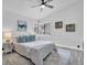 A light filled bedroom features a cozy bed with several pillows, and two side tables with lamps at 3047 Bolt Dr, Palm Harbor, FL 34685