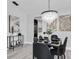 Dining room with modern light fixture, six chairs, and decorative console table at 3047 Bolt Dr, Palm Harbor, FL 34685