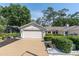 Well-maintained one-story home with manicured landscaping and a two-car garage on a sunny day at 3047 Bolt Dr, Palm Harbor, FL 34685