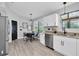 Well-lit kitchen with stainless steel appliances, a breakfast nook, and modern lighting at 3047 Bolt Dr, Palm Harbor, FL 34685