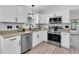 Modern kitchen with white cabinets, stainless steel appliances, and stylish backsplash at 3047 Bolt Dr, Palm Harbor, FL 34685