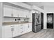 Kitchen featuring white cabinets, stainless steel refrigerator, and modern countertops at 3047 Bolt Dr, Palm Harbor, FL 34685