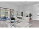Open living room with neutral decor, large glass doors, and stylish furniture at 3047 Bolt Dr, Palm Harbor, FL 34685