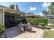 Charming outdoor patio with a table set, ideal for alfresco dining and entertaining at 3047 Bolt Dr, Palm Harbor, FL 34685