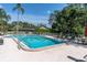 Inviting community pool surrounded by lush greenery and comfortable lounge chairs at 3047 Bolt Dr, Palm Harbor, FL 34685