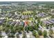 Aerial view of a house nestled in a lush, green, suburban neighborhood with mature trees at 3057 Riders Pass, Odessa, FL 33556