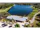 Aerial shot featuring a home with a lake view, a manicured yard, and a stone driveway at 3057 Riders Pass, Odessa, FL 33556
