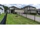 Beautiful property with a manicured lawn, fenced yard, and screened-in patio for outdoor living at 3057 Riders Pass, Odessa, FL 33556