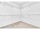 Walk-in closet featuring built-in wire racks and neutral carpeting offers ample storage at 3057 Riders Pass, Odessa, FL 33556