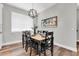 Dining room with a wooden table and chairs, illuminated by a modern pendant light fixture at 3057 Riders Pass, Odessa, FL 33556