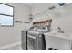 Functional laundry room featuring stainless steel appliances, a utility sink, and ample storage at 3057 Riders Pass, Odessa, FL 33556