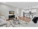 Open floor plan with a bright living room adjacent to a modern kitchen with a breakfast bar at 3057 Riders Pass, Odessa, FL 33556