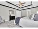Spacious main bedroom with tray ceiling, fan, and stylish furnishings at 3057 Riders Pass, Odessa, FL 33556