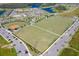 Aerial view of community sports fields, including baseball and soccer fields, surrounded by new construction homes at 3057 Riders Pass, Odessa, FL 33556