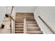 Overhead shot of wooden staircase featuring hardwood floors, white railings, and natural light at 3057 Riders Pass, Odessa, FL 33556