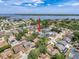The aerial view shows a single-Gathering home in a community with lake access and lush greenery, highlighting its desirable location at 3074 Cara Ct, Palm Harbor, FL 34684