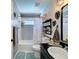 Stylish bathroom with decorative tile, tropical wallpaper, and modern fixtures at 3074 Cara Ct, Palm Harbor, FL 34684