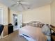 Comfortable bedroom featuring neutral walls, ceiling fan, and access to an ensuite bathroom at 3074 Cara Ct, Palm Harbor, FL 34684