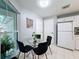 Bright breakfast nook area with a glass table, seating for four, and views of the outdoors at 3074 Cara Ct, Palm Harbor, FL 34684