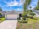 Charming single-story home with a well-manicured lawn, mature landscaping, and a two-car garage at 3074 Cara Ct, Palm Harbor, FL 34684