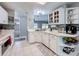 Bright kitchen boasts white cabinetry, modern appliances, and eye-catching backsplash tiles at 3074 Cara Ct, Palm Harbor, FL 34684