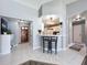 Open-concept with tile flooring, featuring a breakfast bar connecting to a clean and bright kitchen space at 3074 Cara Ct, Palm Harbor, FL 34684