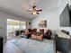 Comfortable living room with vaulted ceiling, ceiling fan and sliding glass doors to the outdoor lanai at 3074 Cara Ct, Palm Harbor, FL 34684