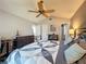 Spacious main bedroom with wood floors, ceiling fan and access to two bathrooms at 3074 Cara Ct, Palm Harbor, FL 34684