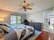 Comfortable main bedroom with decorative fan, wood floors, and a large window at 3074 Cara Ct, Palm Harbor, FL 34684