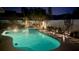 Inviting backyard pool and hot tub with lush landscaping and ambient lighting for evening relaxation at 3074 Cara Ct, Palm Harbor, FL 34684