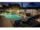 Relaxing pool area with patio furniture, including lounge chairs and an outdoor dining set for entertaining at 3074 Cara Ct, Palm Harbor, FL 34684