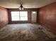 Spacious living room ready for renovation, featuring an inviting window and awaiting new flooring at 34534 Orchid Pkwy, Dade City, FL 33523