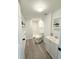 Bathroom featuring a white vanity, a shower, and grey vinyl flooring at 3545 Oxford Dr, Holiday, FL 34691