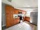 Well-equipped kitchen with stainless steel appliances, ample wood cabinetry, and modern tile backsplash at 3545 Oxford Dr, Holiday, FL 34691