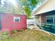 Fenced backyard features a utility shed, landscaping, and a screened lanai with seating at 37733 14Th Ave, Zephyrhills, FL 33542