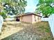 Spacious backyard view featuring grass, a patio area, and a privacy fence at 37733 14Th Ave, Zephyrhills, FL 33542