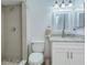 Bathroom features tiled walk-in shower and vanity with granite counters and white cabinets at 37733 14Th Ave, Zephyrhills, FL 33542
