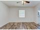 Open bedroom featuring wood-look flooring, a ceiling fan, and a window at 37733 14Th Ave, Zephyrhills, FL 33542