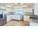 Modern kitchen features white cabinets, stainless steel appliances, and granite counters at 37733 14Th Ave, Zephyrhills, FL 33542