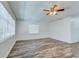 Bright living room featuring two windows and wood floors with a ceiling fan at 37733 14Th Ave, Zephyrhills, FL 33542