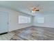 Bright living room featuring two windows and wood floors with a ceiling fan at 37733 14Th Ave, Zephyrhills, FL 33542