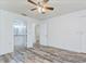 Main bedroom leading to bathroom and closet featuring wood floors and white trim at 37733 14Th Ave, Zephyrhills, FL 33542